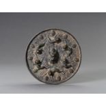 A TANG-STYLE BRONZE 'LIONS AND GRAPEVINES' MIRROR
