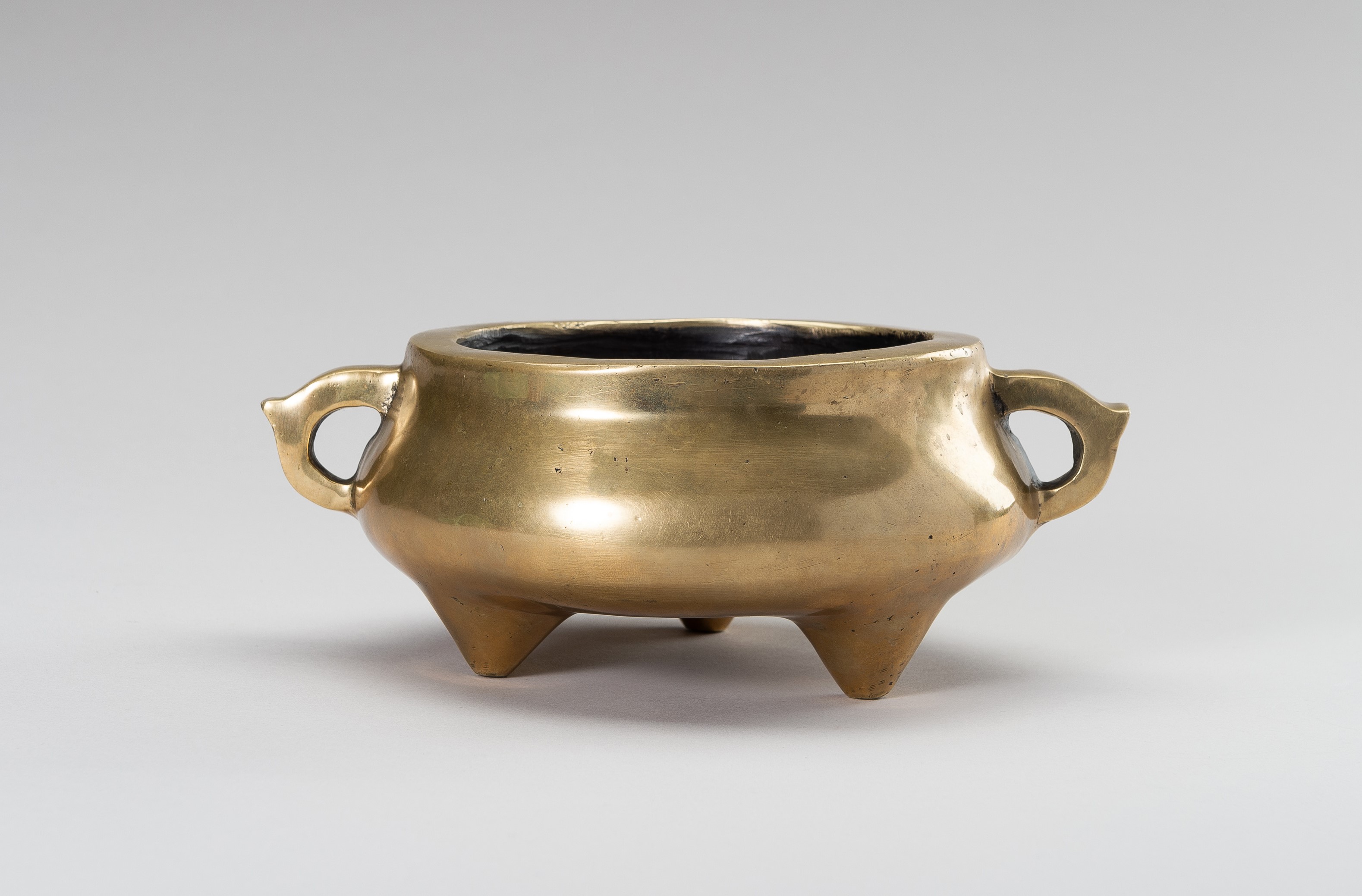 A MASSIVE GILT-BRONZE TRIPOD CENSER