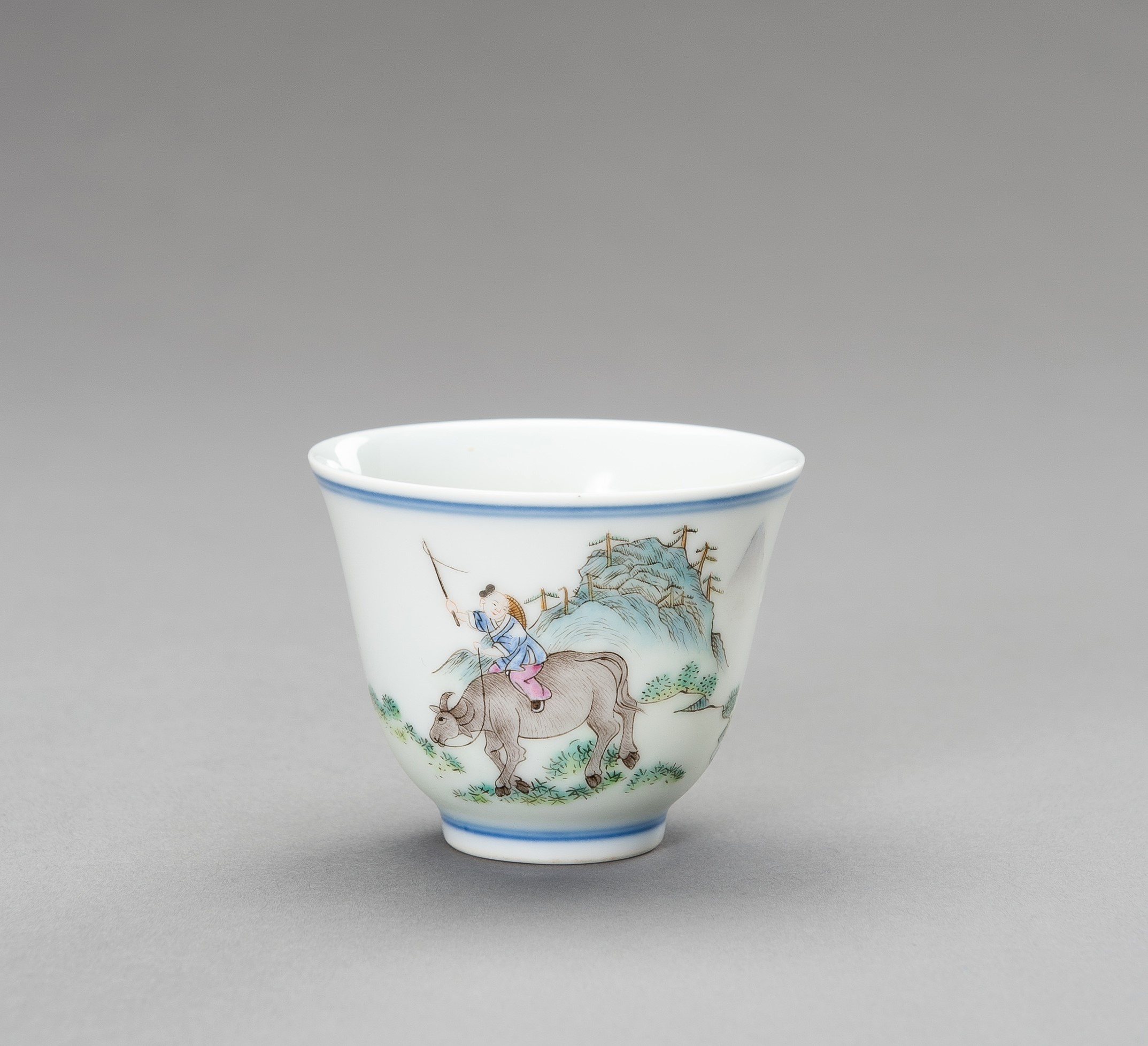 A 'BOY ON OX' PORCELAIN CUP, QING
