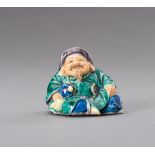 A POLYCHROME YAKIMONO PORCELAIN NETSUKE OF DAIKOKU