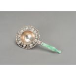 A SILVER-PLATED TEA STRAINER WITH JADEITE HANDLE