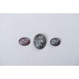 A SET OF THREE CARVED INTAGLIO SEALS