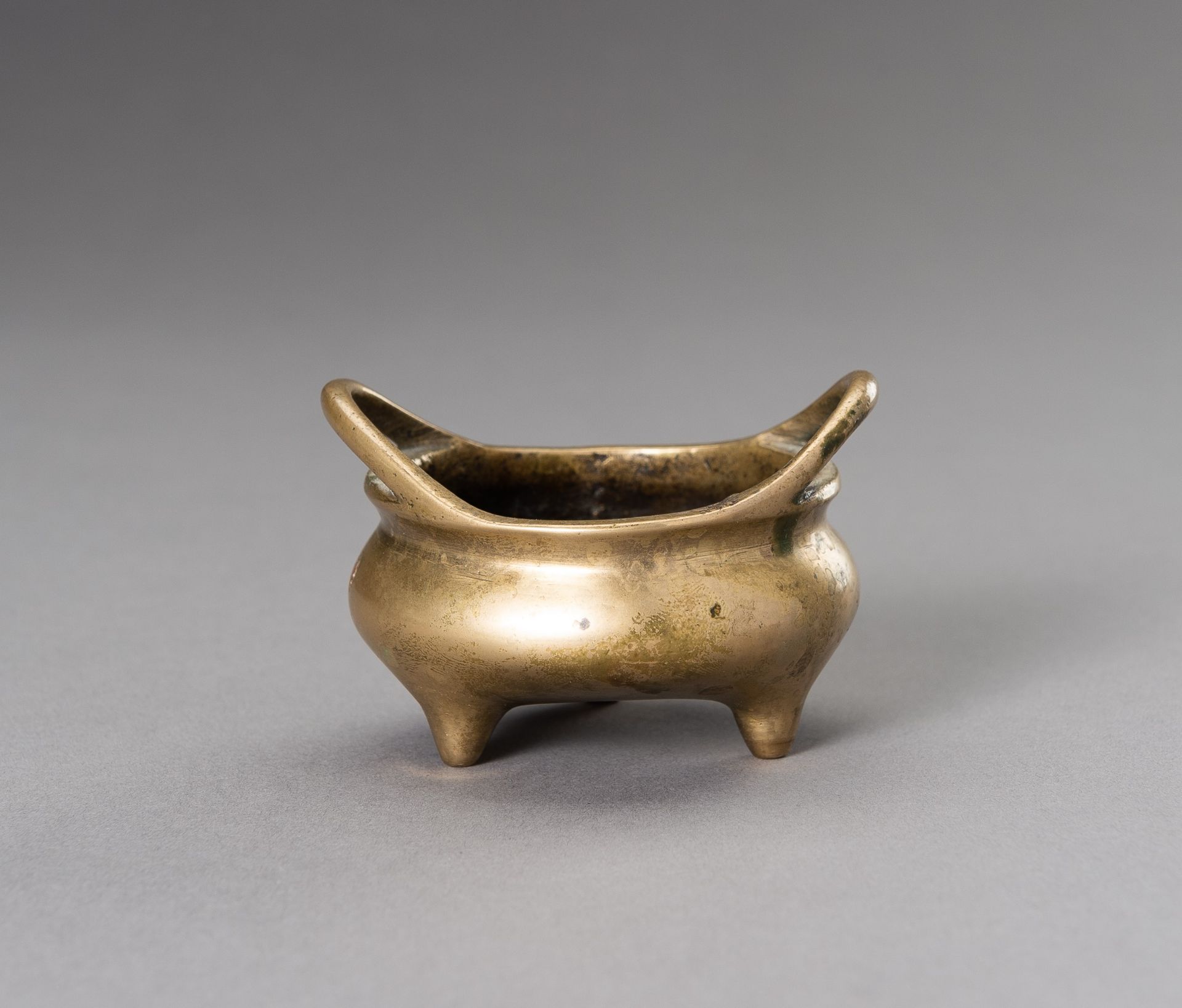 A MINIATURE BRONZE TRIPOD CENSER, QING DYNASTY