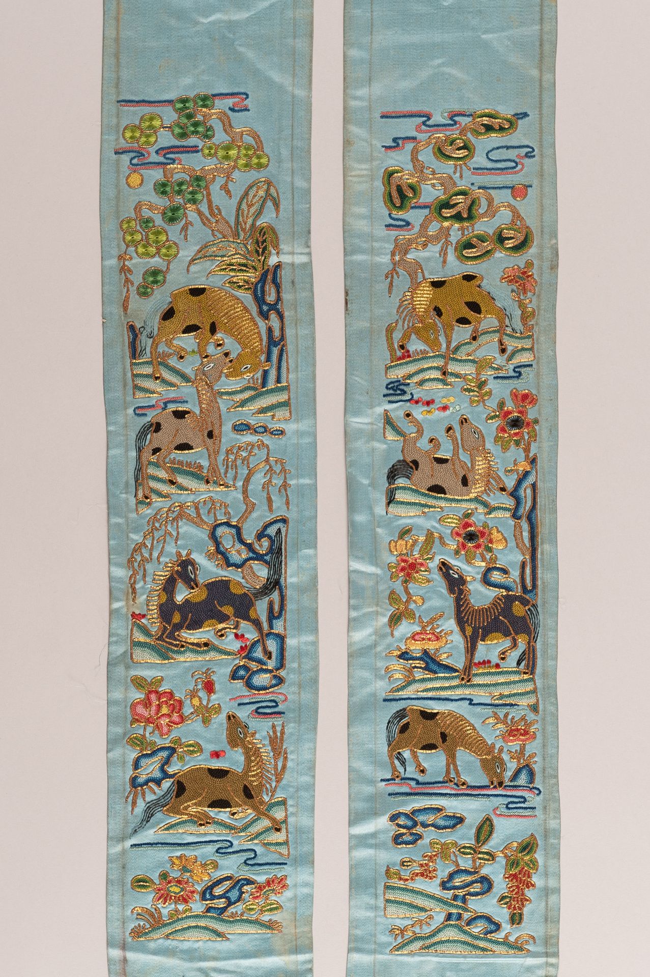 A PAIR OF 'EIGHT HORSES OF MUWANG' SILK SLEEVE BANDS, LATE QING DYNASTY