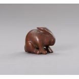 A WOOD NETSUKE OF A RABBIT