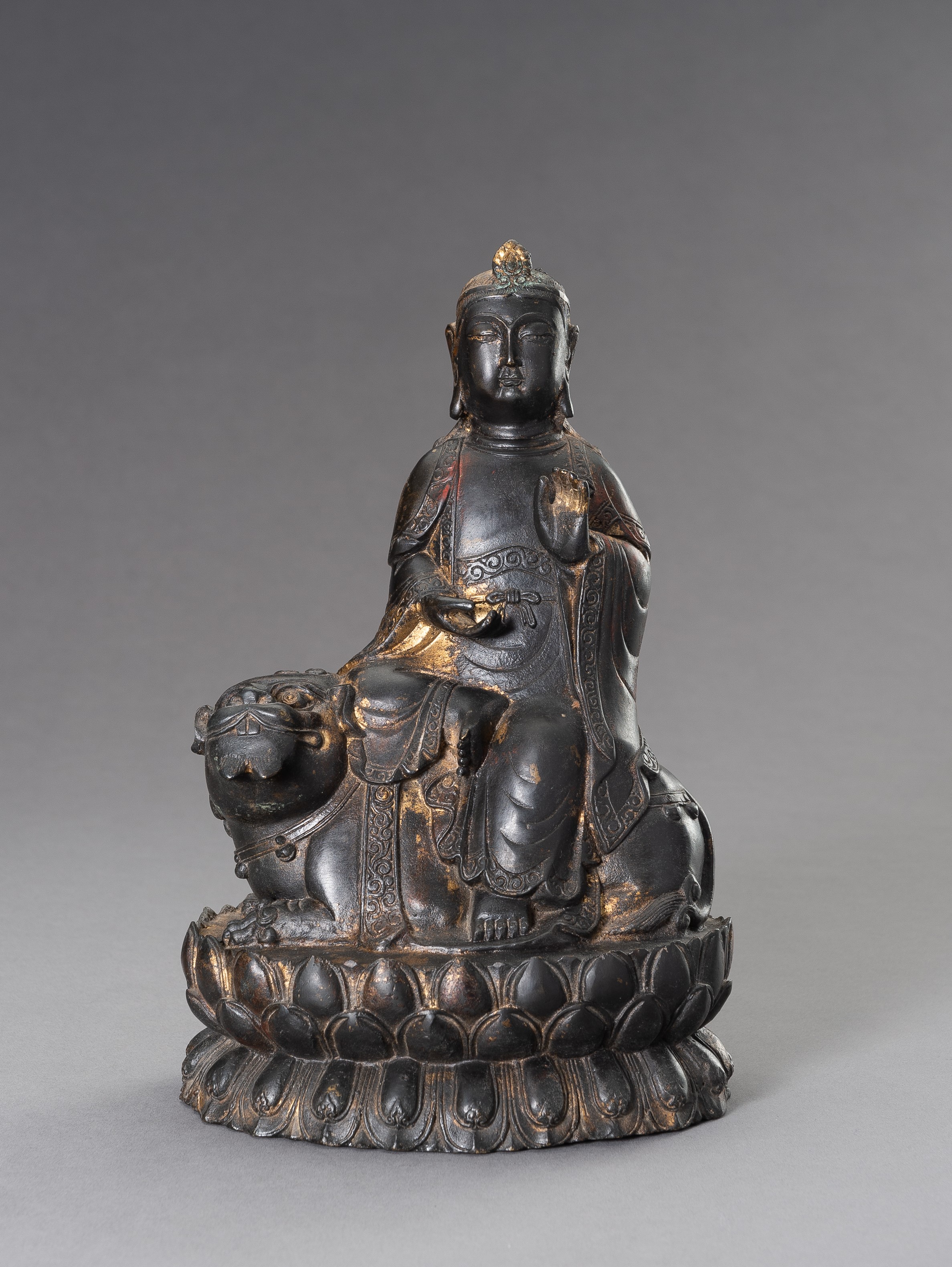 A BRONZE FIGURE OF MANJUSHRI SEATED ON A LION, 20TH CENTURY