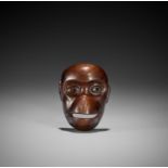 A WOOD MASK NETSUKE OF A SARU (MONKEY)