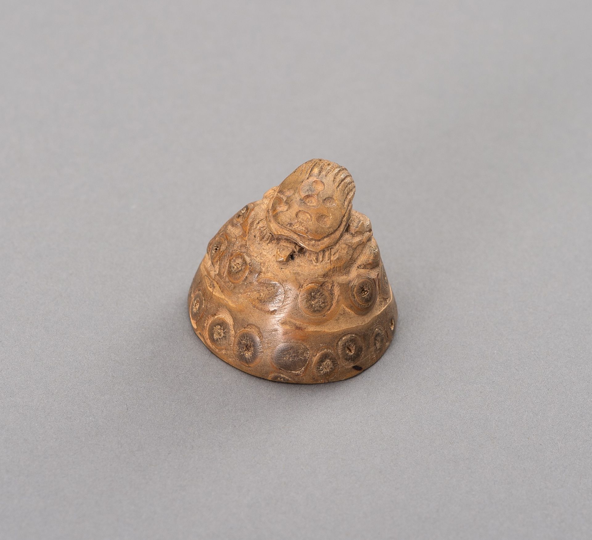 A BAMBOO NETSUKE OF A MINOGAME ON ROCK