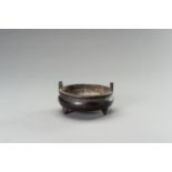 A BRONZE TRIPOD CENSER