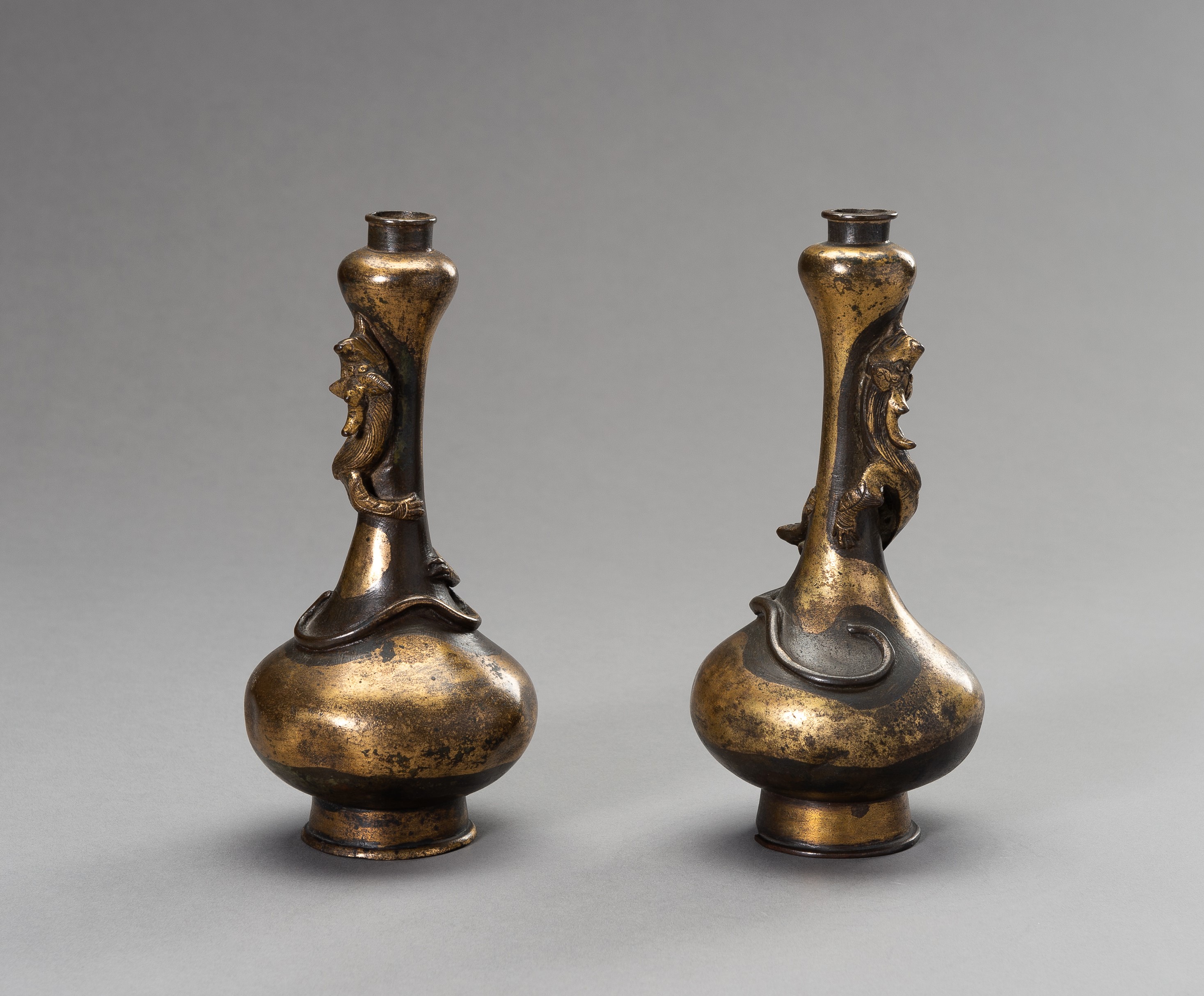 A PAIR OF PARCEL-GILT GARLIC HEAD VASES, 17TH CENTURY