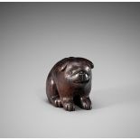 RANICHI: A DARK WOOD NETSUKE OF A PUPPY