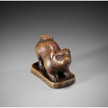 TOSEI: A CHARMING WOOD NETSUKE OF A PUPPY