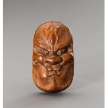 HOZAN: A WOOD SHUNGA NETSUKE OF A BAKEMONO MASK