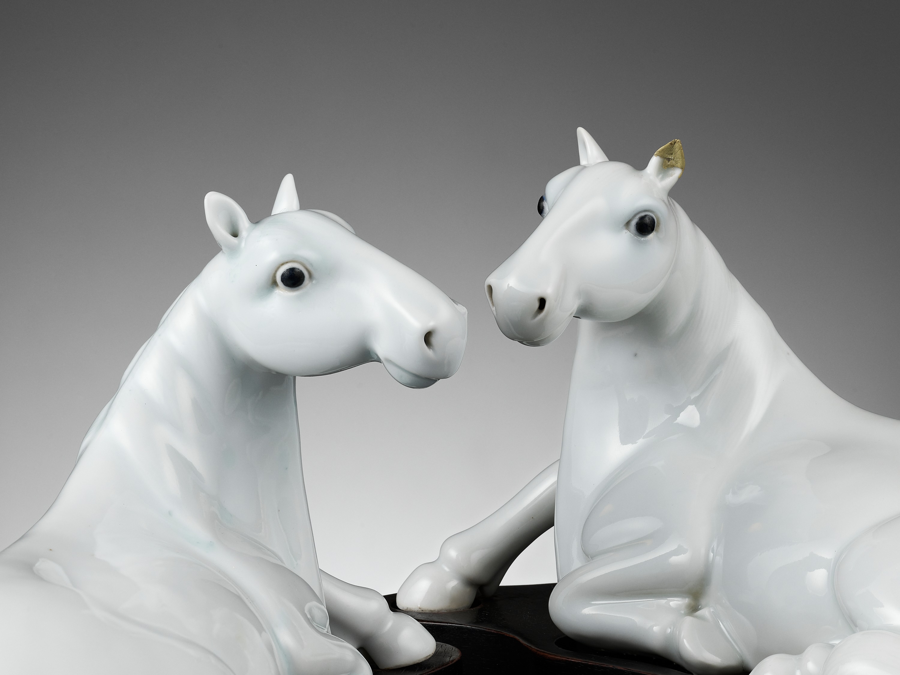 A PAIR OF WHITE-GLAZED FIGURES OF HORSES, QING DYNASTY