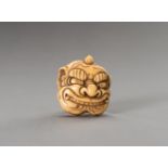 A NETSUKE OF AN ONI MASK