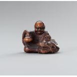 A SIGNED BOXWOOD NETSUKE OF RAKAN HANDAKA