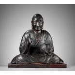 A LACQUERED WOOD FIGURE OF A SEATED BUDDHIST MONK