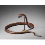 A RARE AND IMPRESSIVE PATINATED BRONZE ARTICULATED MODEL OF A SNAKE