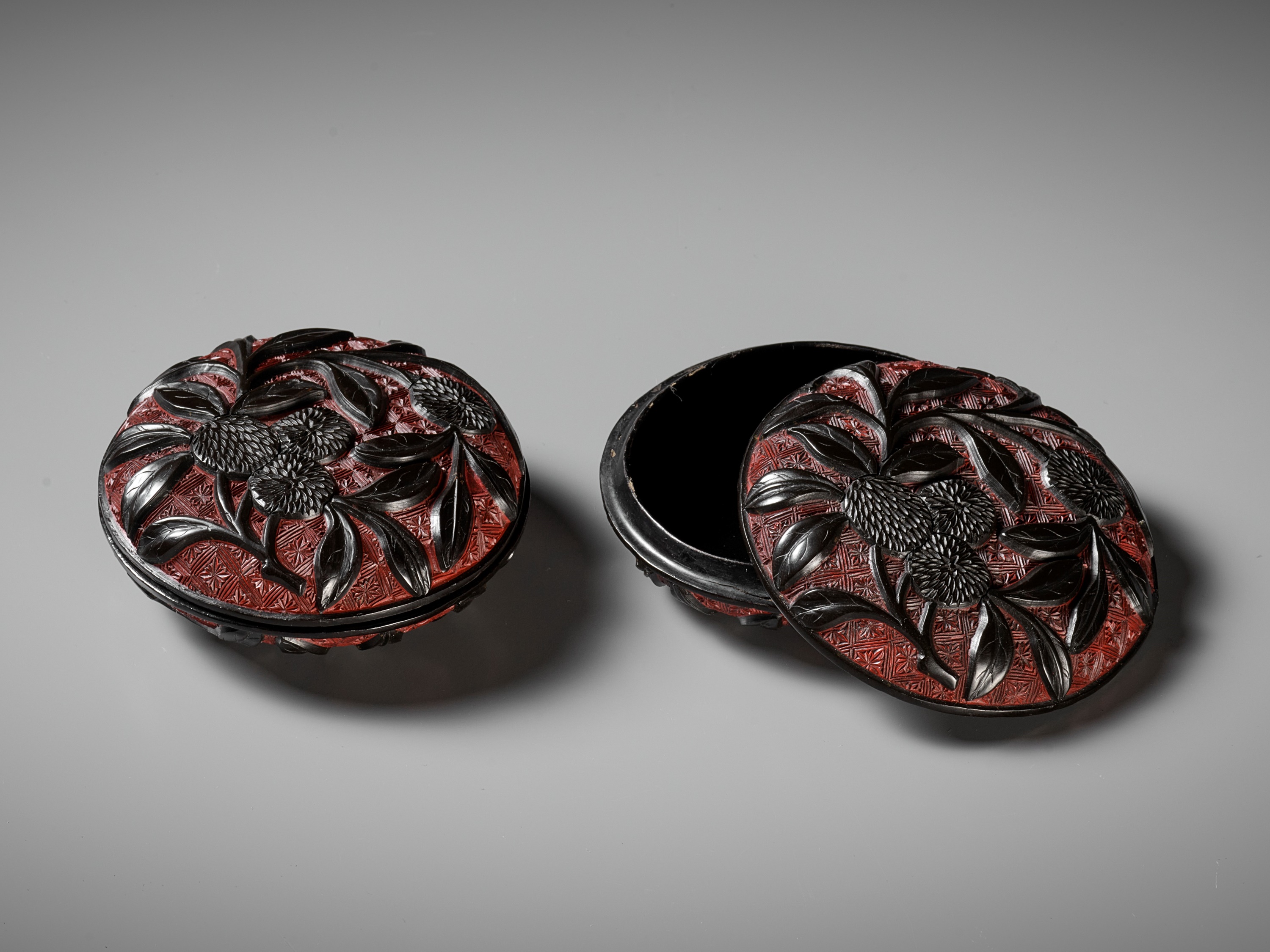 A PAIR OF RED AND BLACK LACQUER 'LYCHEE' BOXES AND COVERS, MING DYNASTY