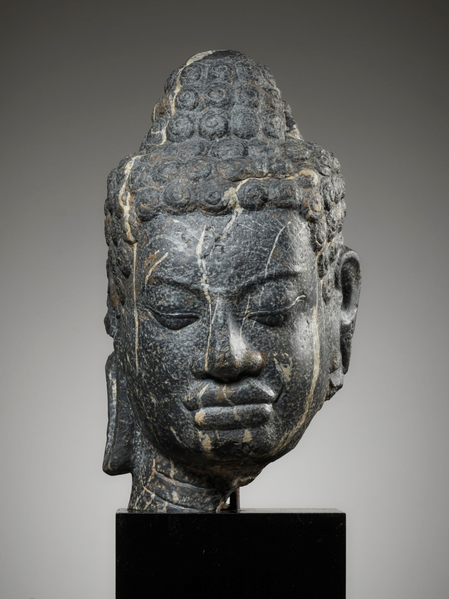 A MONUMENTAL STONE HEAD OF BUDDHA, MON-DVARAVATI PERIOD