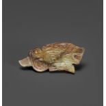 A TIGER-FORM JADE PENDANT, LATE SHANG DYNASTY