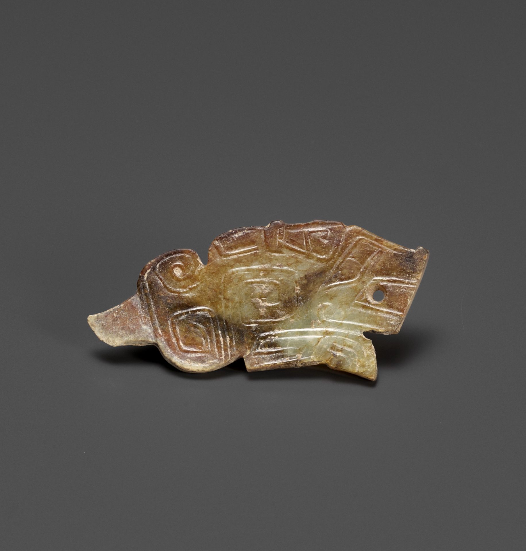 A TIGER-FORM JADE PENDANT, LATE SHANG DYNASTY