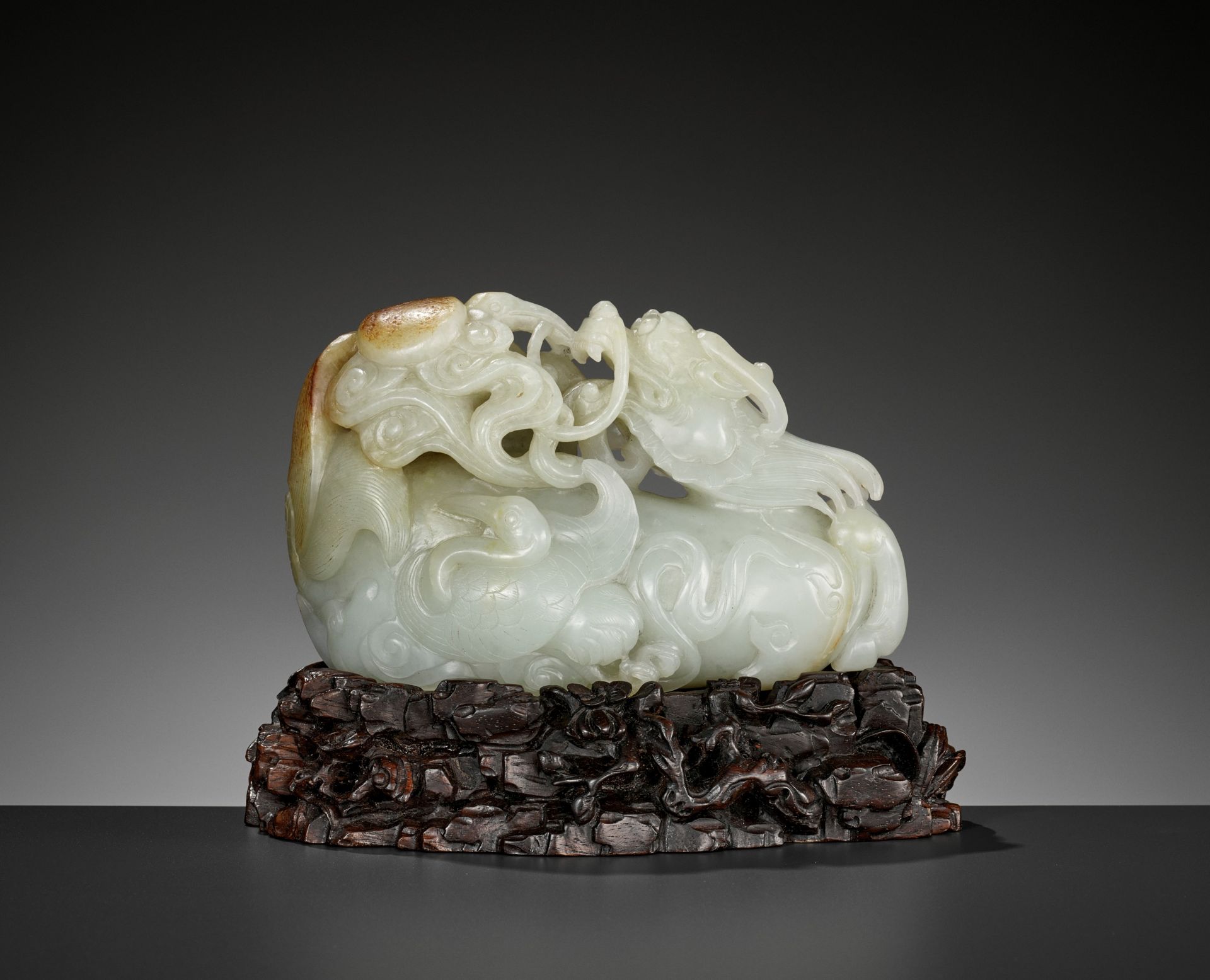 A CELADON AND RUSSET JADE 'QILIN AND CRANES' GROUP, 18TH CENTURY
