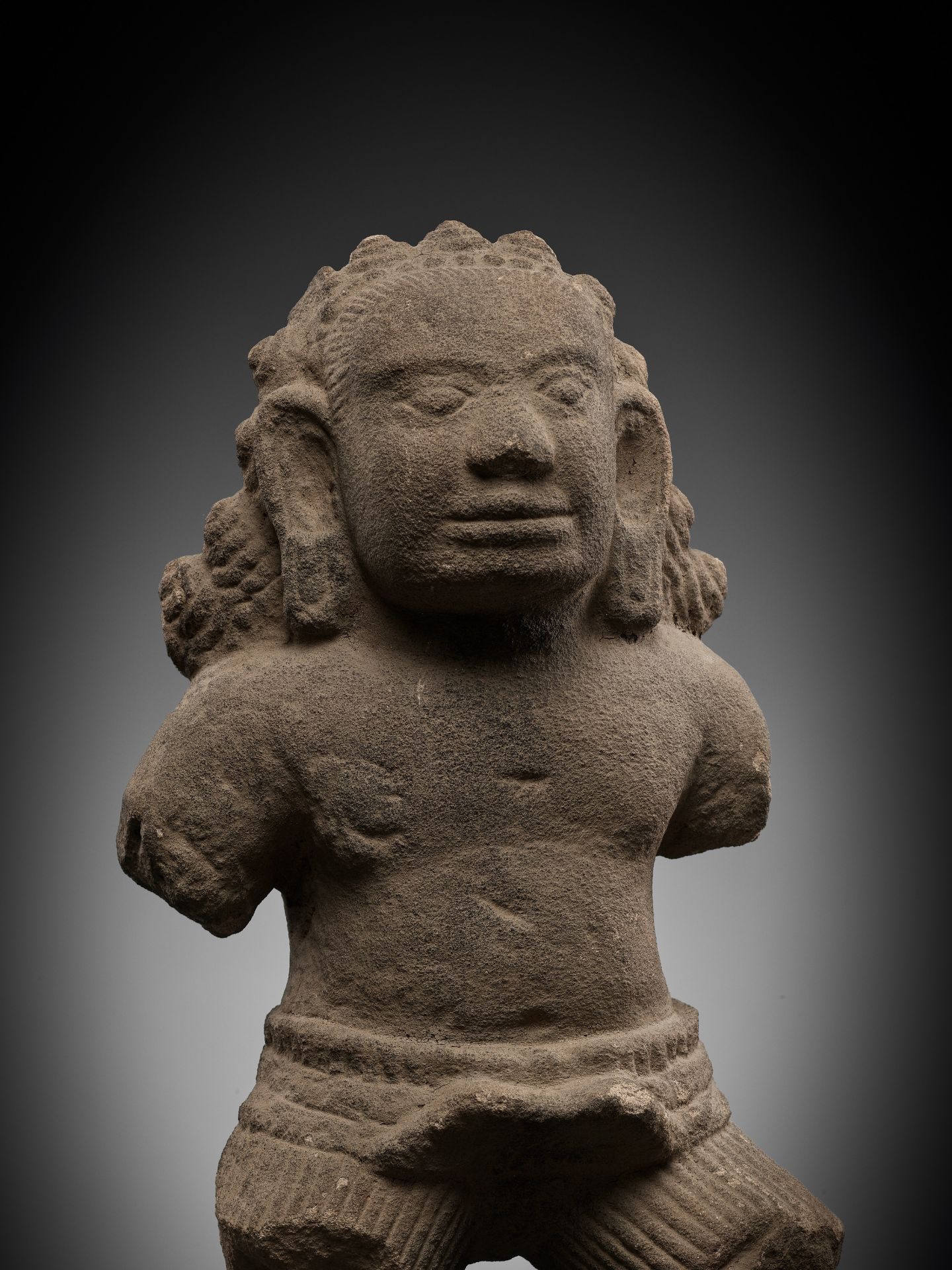 AN EXPRESSIVE SANDSTONE FIGURE OF A RAKSHASA, ANGKOR PERIOD, KOH KER STYLE