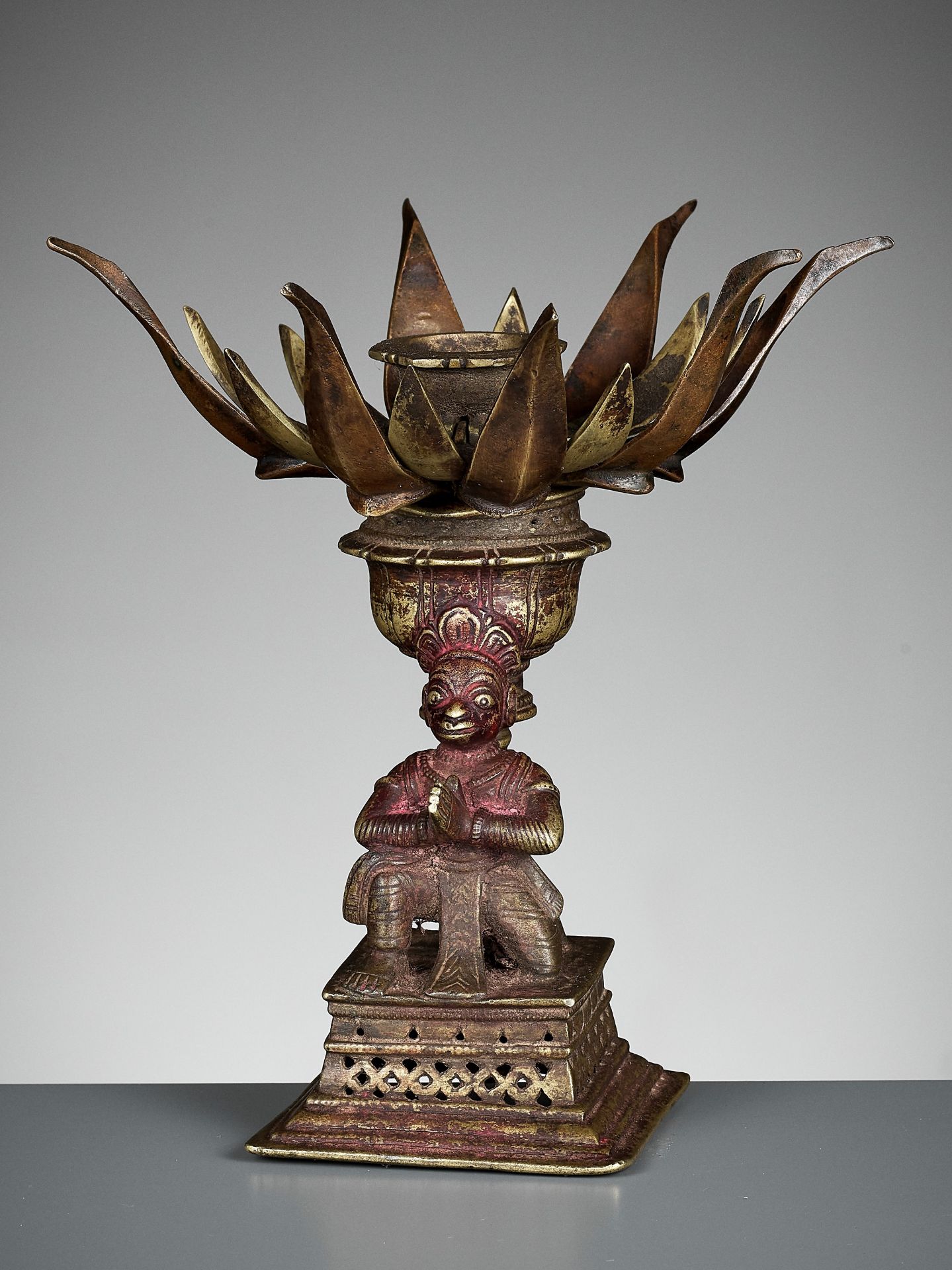 A BRONZE 'LOTUS MANDALA' LINGAM STAND WITH HANUMAN