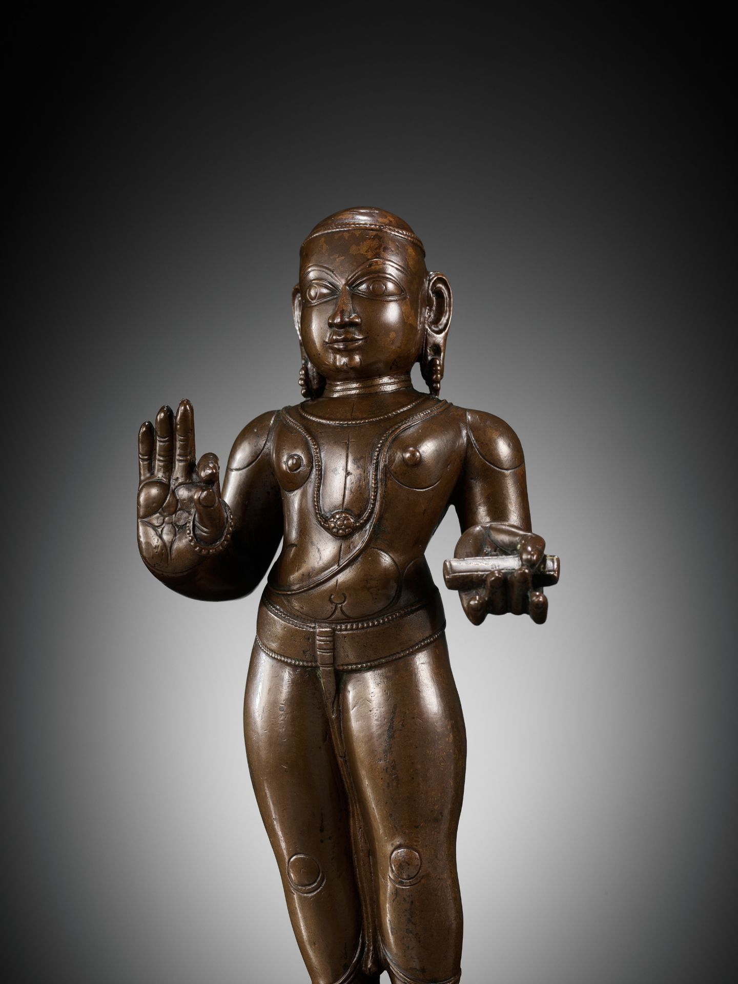 A LARGE COPPER ALLOY FIGURE OF MANIKKAVACAKAR, TAMIL NADU, 14TH-15TH CENTURY