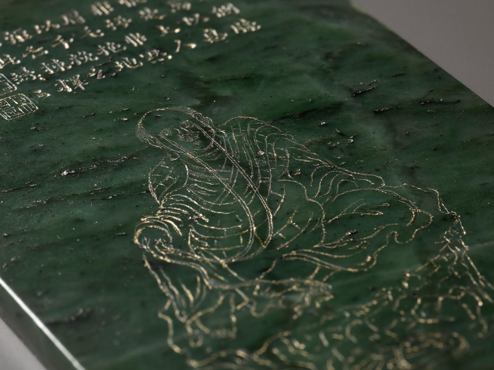 AN IMPERIAL SPINACH-GREEN JADE 'LUOHAN' PANEL AFTER GUANXIU (823-912 AD), WITH A POETIC EULOGY BY HO