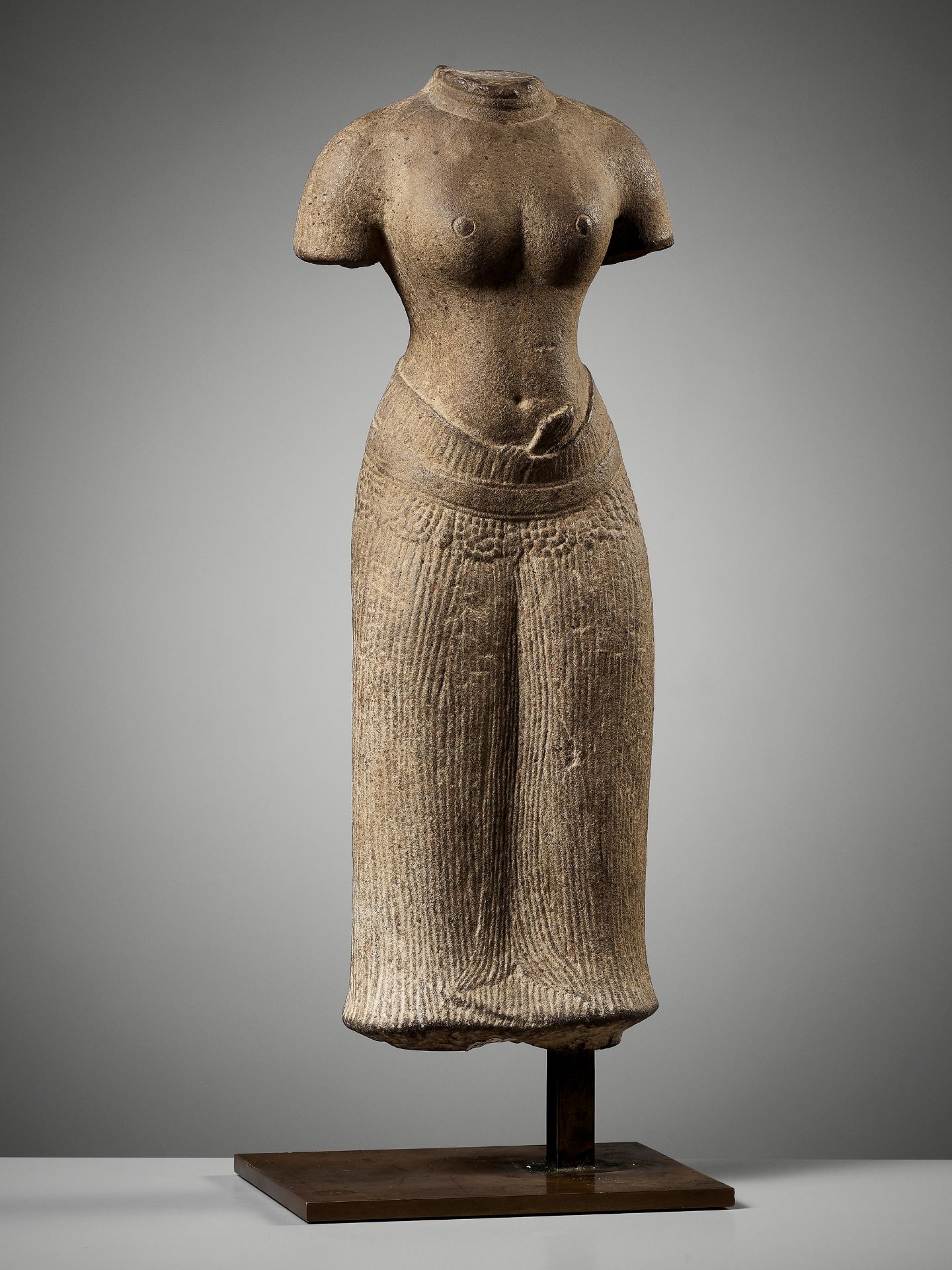 A SUBLIME SANDSTONE TORSO OF UMA, ANGKOR PERIOD, BAPHUON STYLE