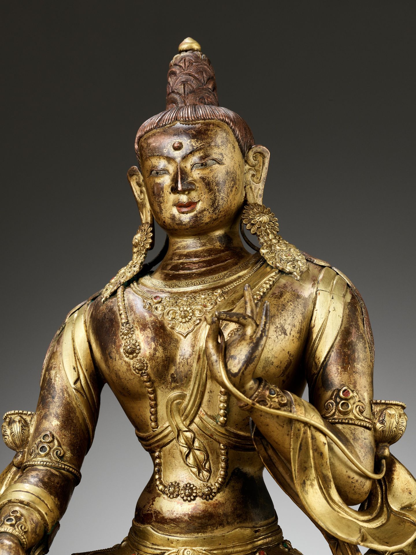 A CAST AND REPOUSSE GILT COPPER ALLOY FIGURE OF GREEN TARA, QIANLONG PERIOD