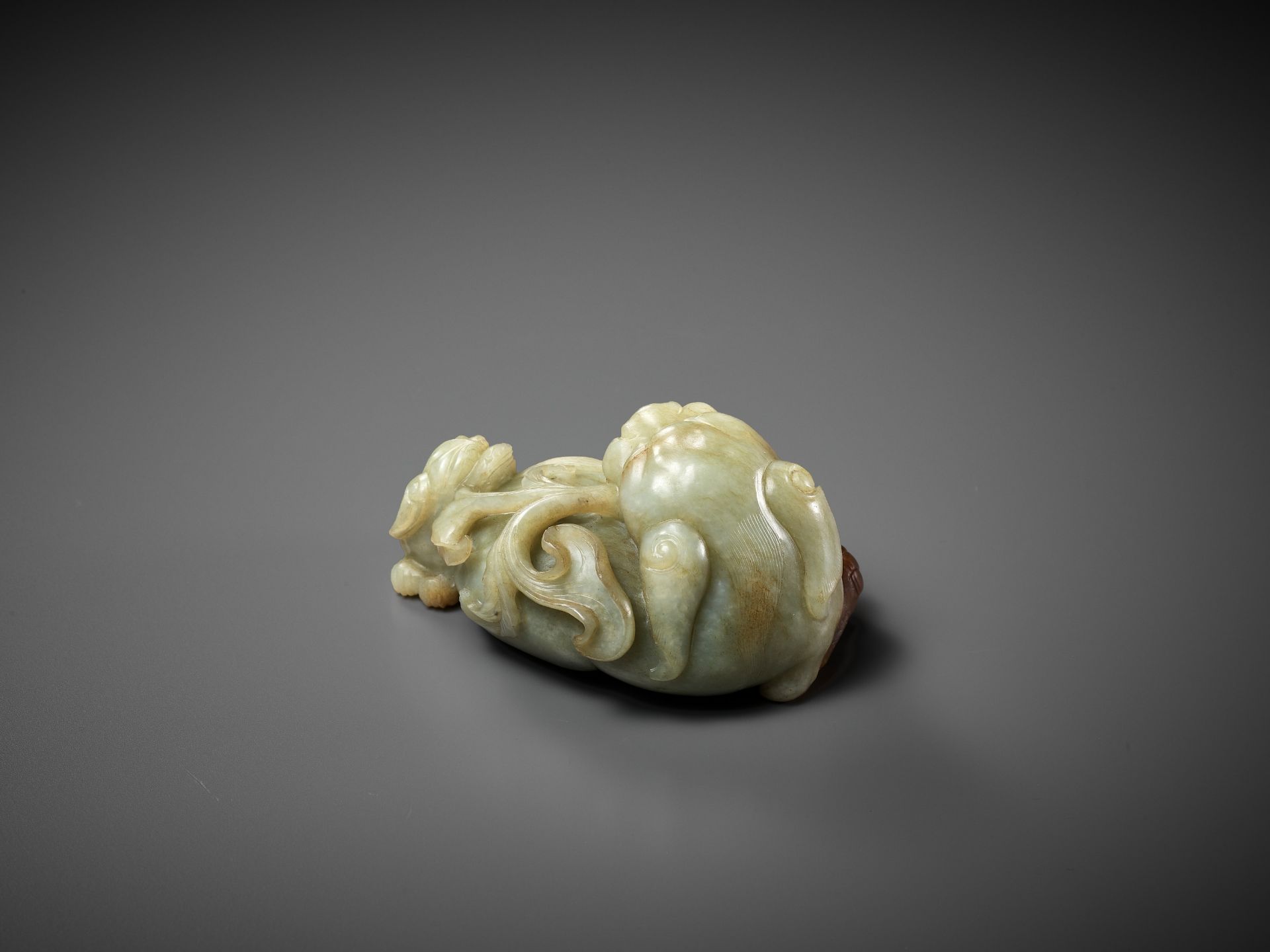 A CELADON AND RUSSET JADE 'BUDDHIST LION AND CUB' GROUP, 17TH CENTURY - Image 8 of 11