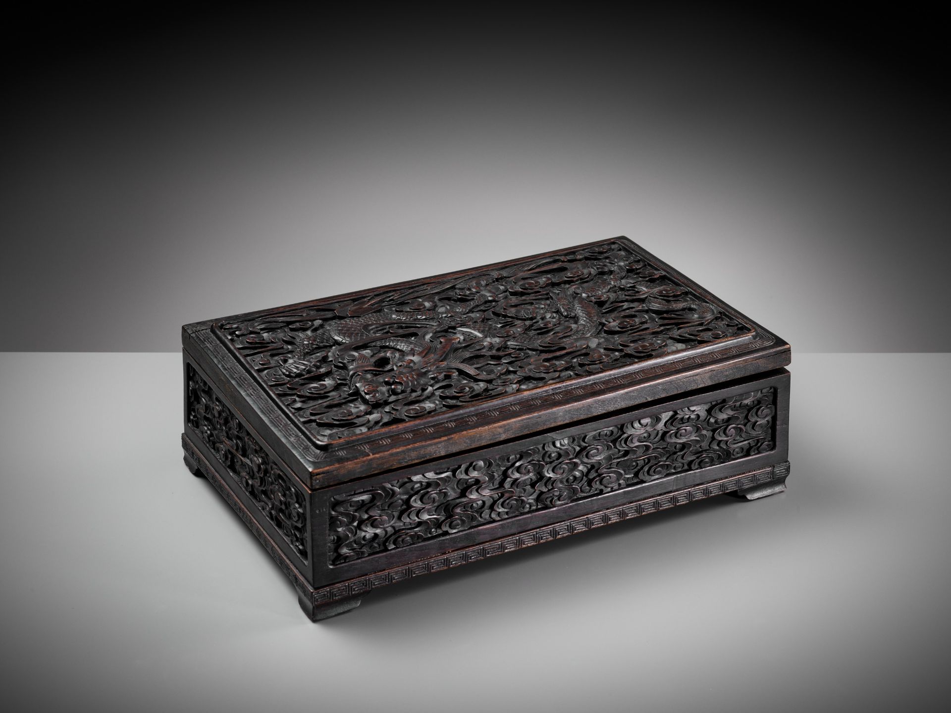 AN IMPERIAL 'DRAGON' HARDWOOD CHEST, COMMEMORATING THE RENOVATION OF THE JADE PEAK PAGODA BY EMPEROR