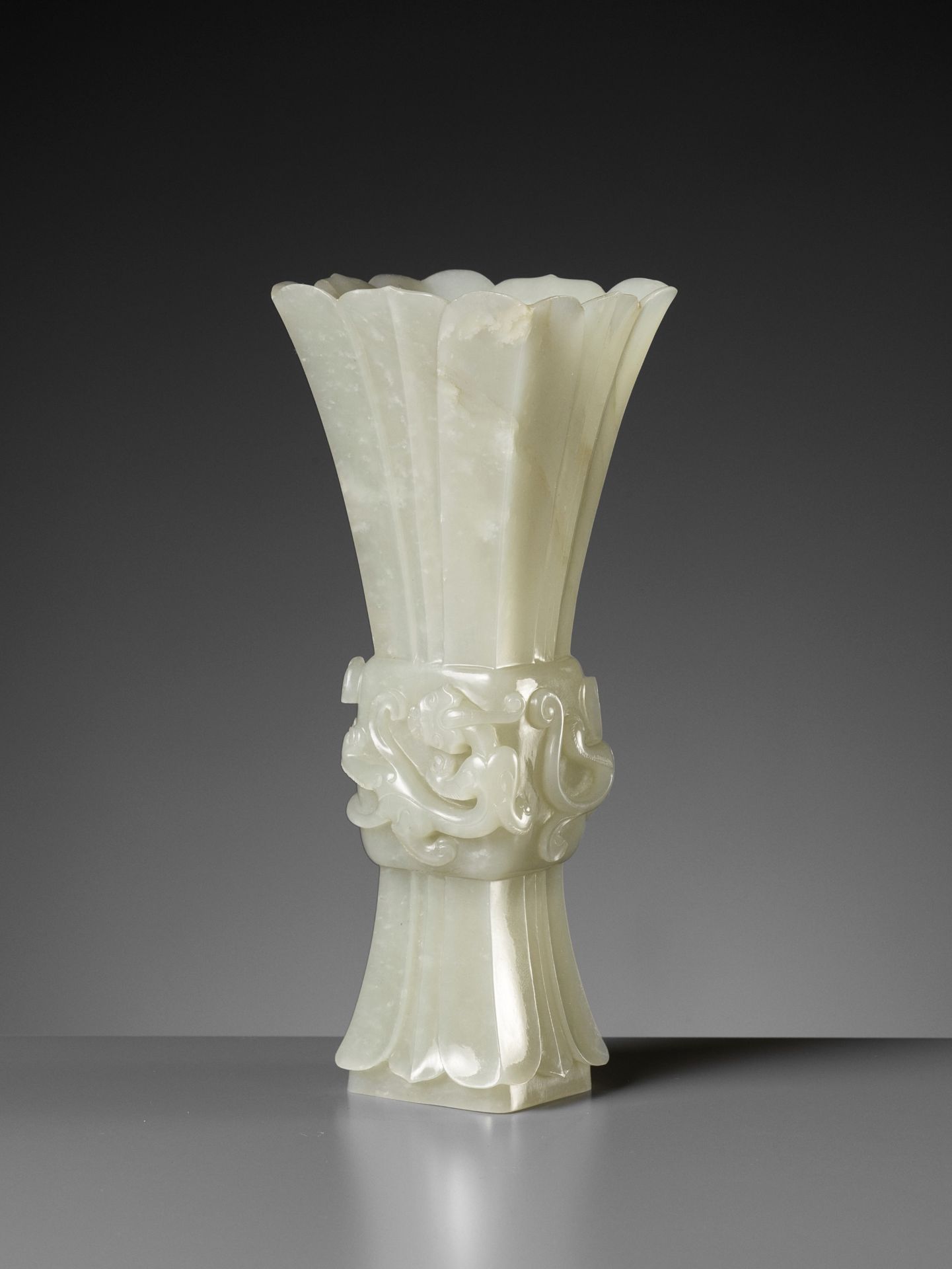 A PALE CELADON JADE PETAL-LOBED ARCHAISTIC 'CHILONG' VASE, QIANLONG PERIOD