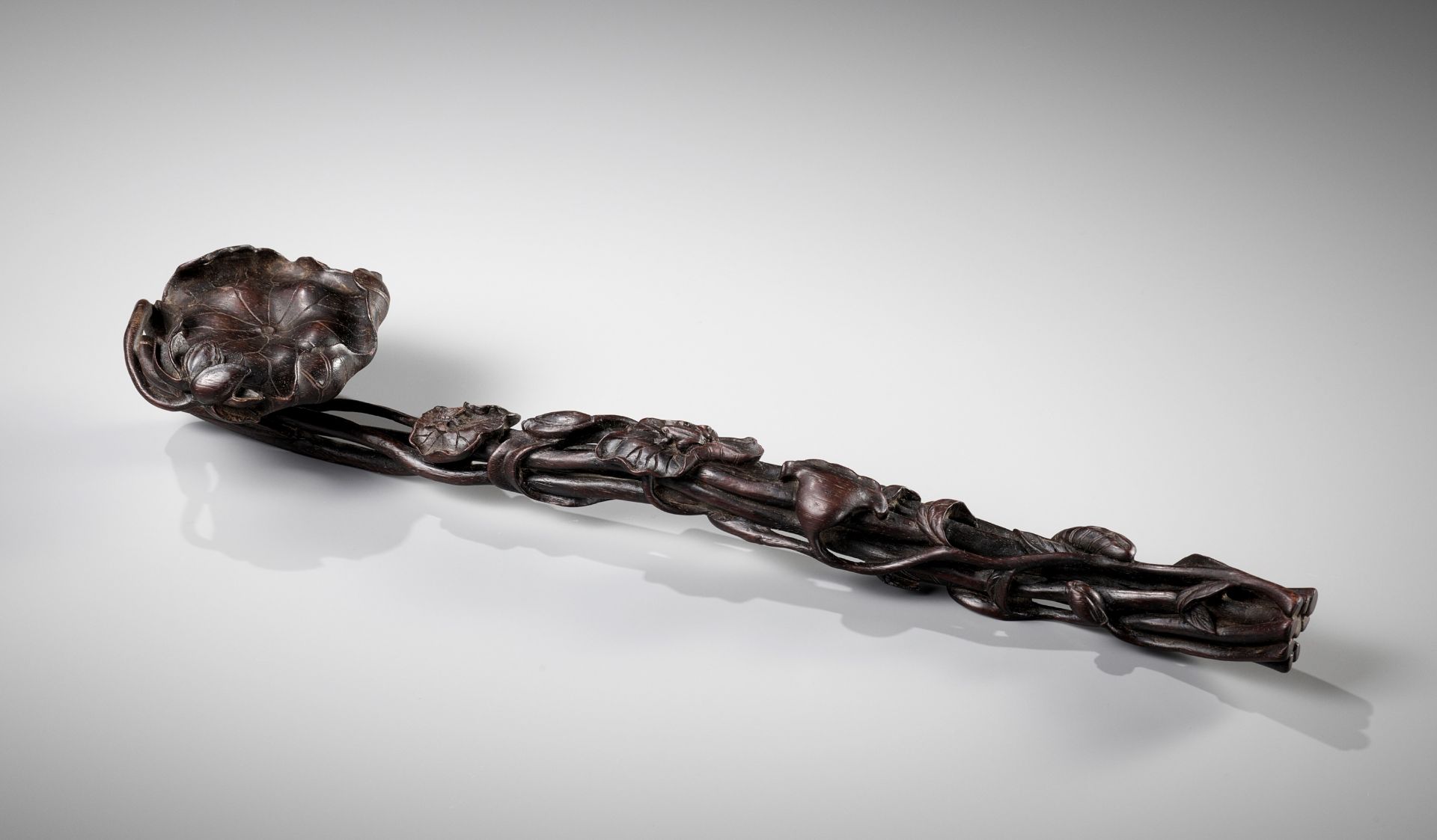 A ZITAN WOOD 'LOTUS' RUYI SCEPTER, PROBABLY IMPERIAL