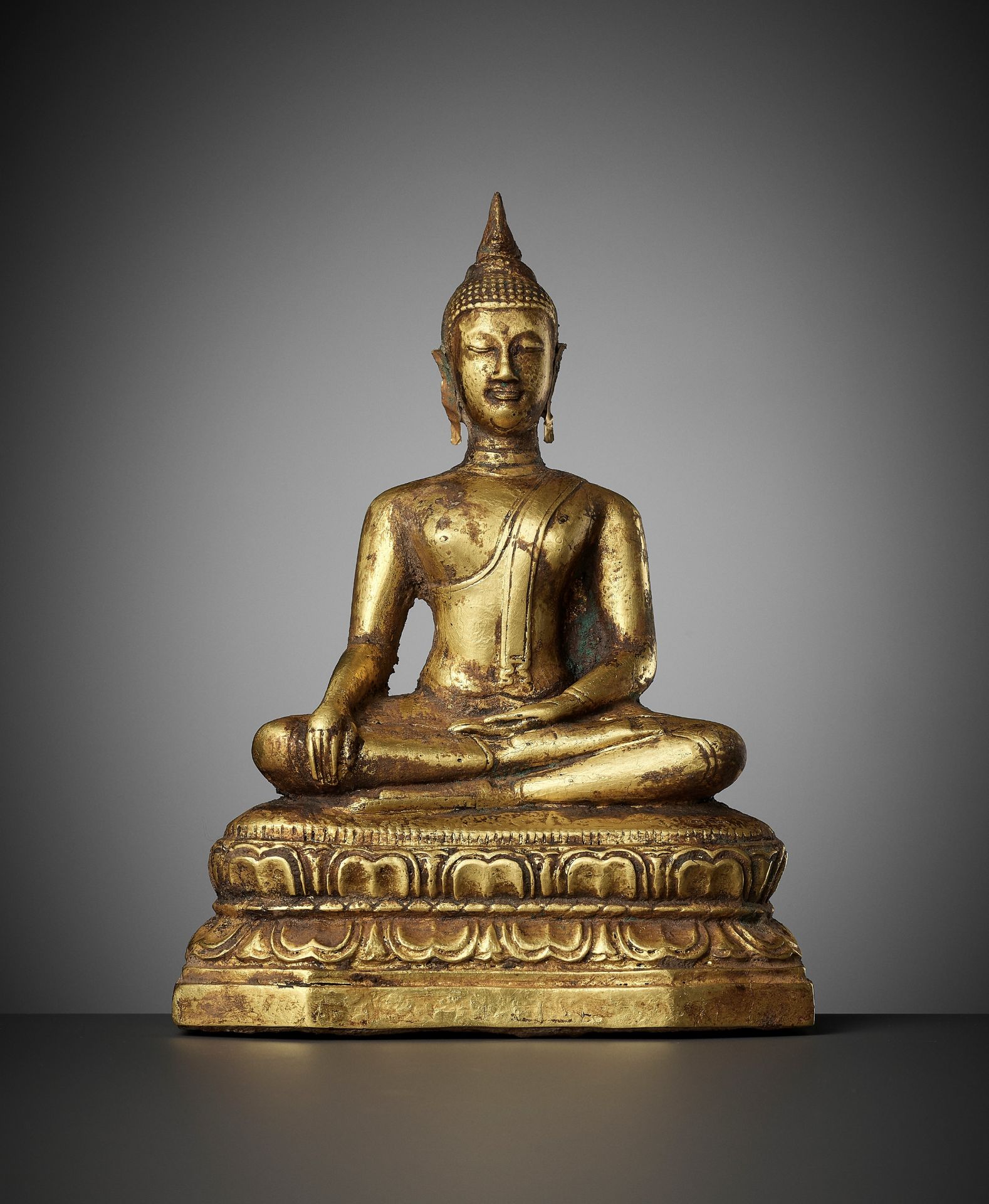 A GOLD REPOUSSE FIGURE OF BUDDHA SHAKYAMUNI, AYUTTHAYA KINGDOM, 1351-1767
