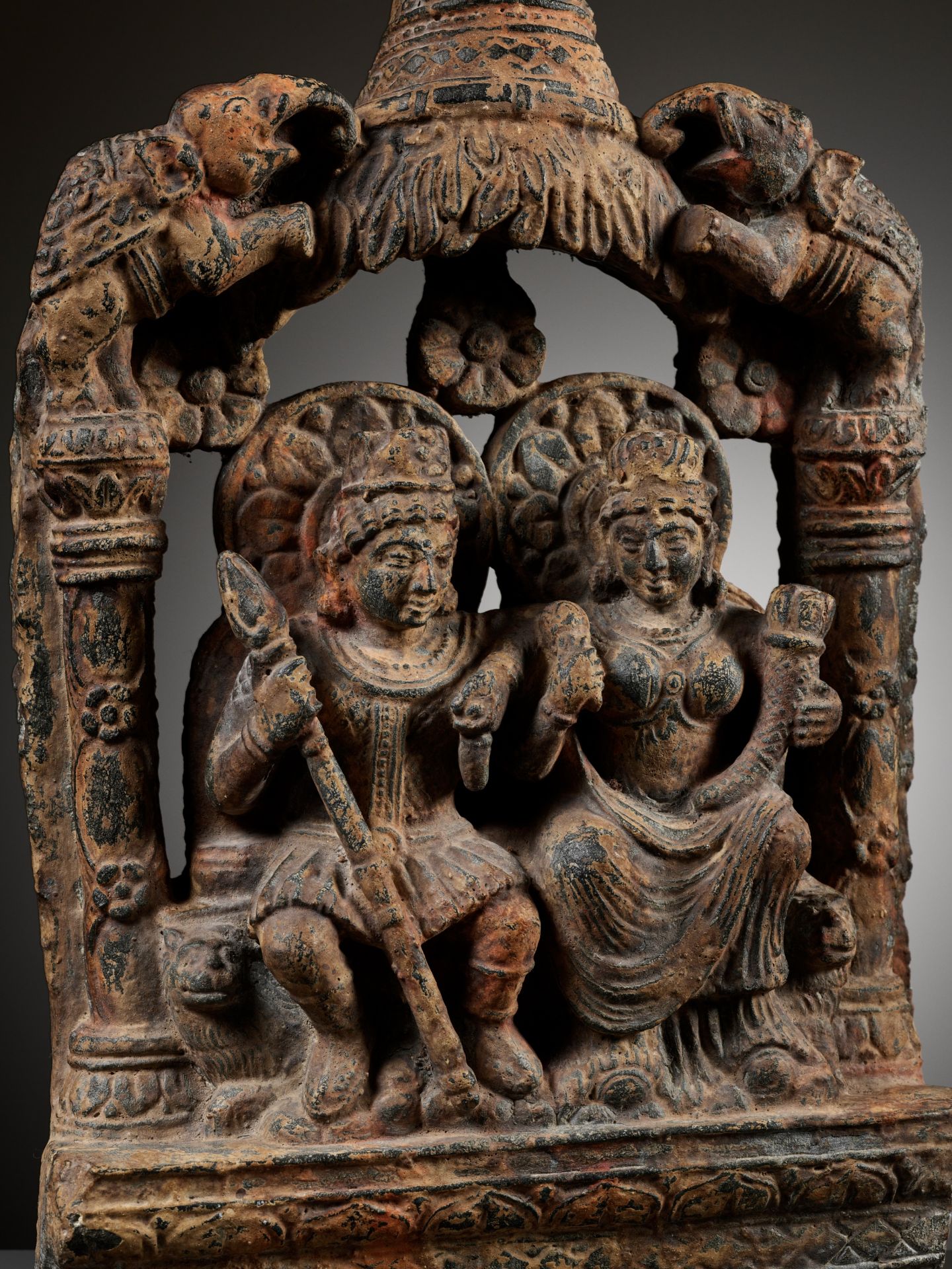 A SANDSTONE GROUP DEPICTING HARITI AND PANCHIKA