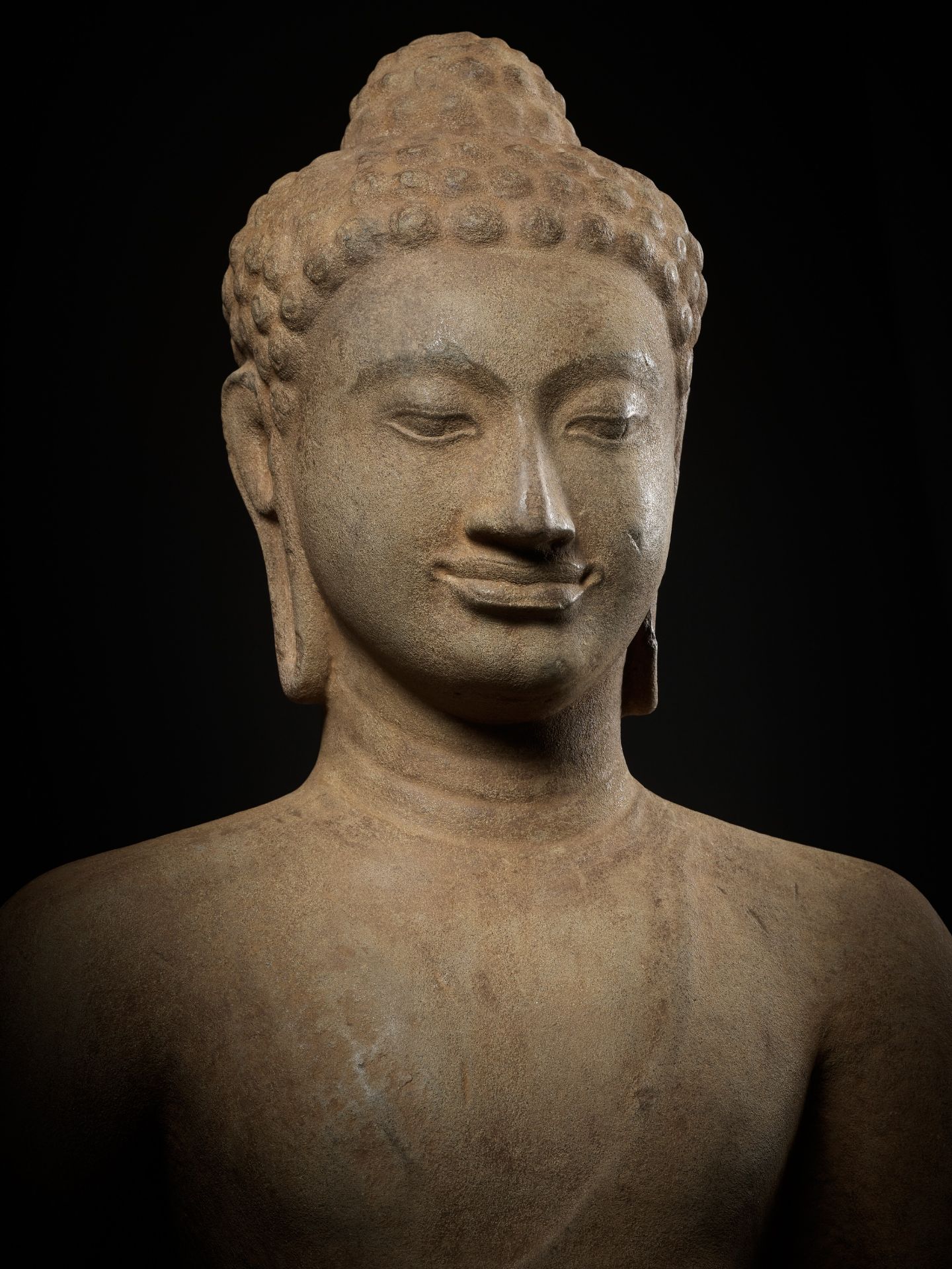 A MONUMENTAL AND HIGHLY IMPORTANT SANDSTONE FIGURE OF BUDDHA, PRE-ANGKOR PERIOD