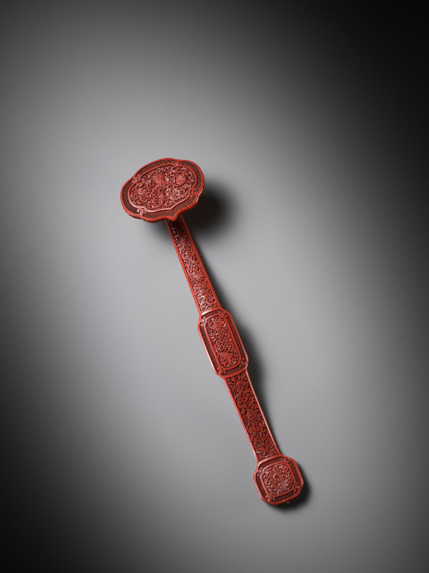 A CARVED CINNABAR LACQUER 'BAJIXIANG' RUYI SCEPTER, QING DYNASTY