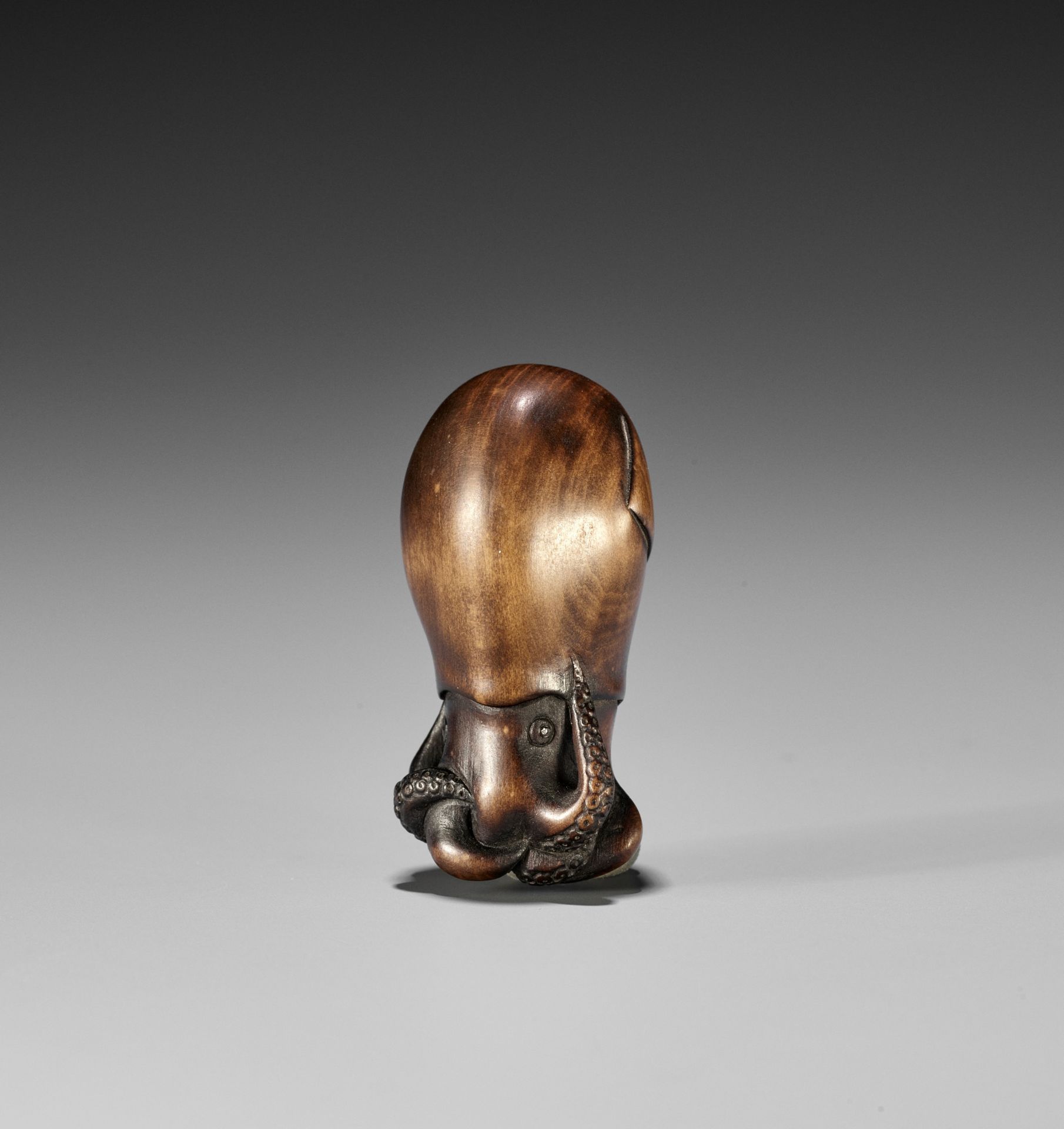 YOSUI: A RARE WOOD NETSUKE OF A SQUID