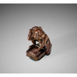 DEME: A RARE AND UNUSUAL EDO SCHOOL WOOD NETSUKE OF A BLIND RAT CATCHER