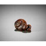 TOMOKAZU: A RARE WOOD NETSUKE OF FIVE SNAILS