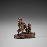 SHOKO: A FINE WOOD NETSUKE OF RAIJIN WITH BATHING WOMAN