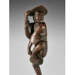 TOMOCHIKA: A SUPERB AND RARE WOOD NETSUKE OF A SPARROW DANCER (SUZUME ODORI)