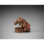 A RARE AND HUMOROUS WOOD AND NEGORO LACQUER NETSUKE OF HOTEI TAKING A BATH