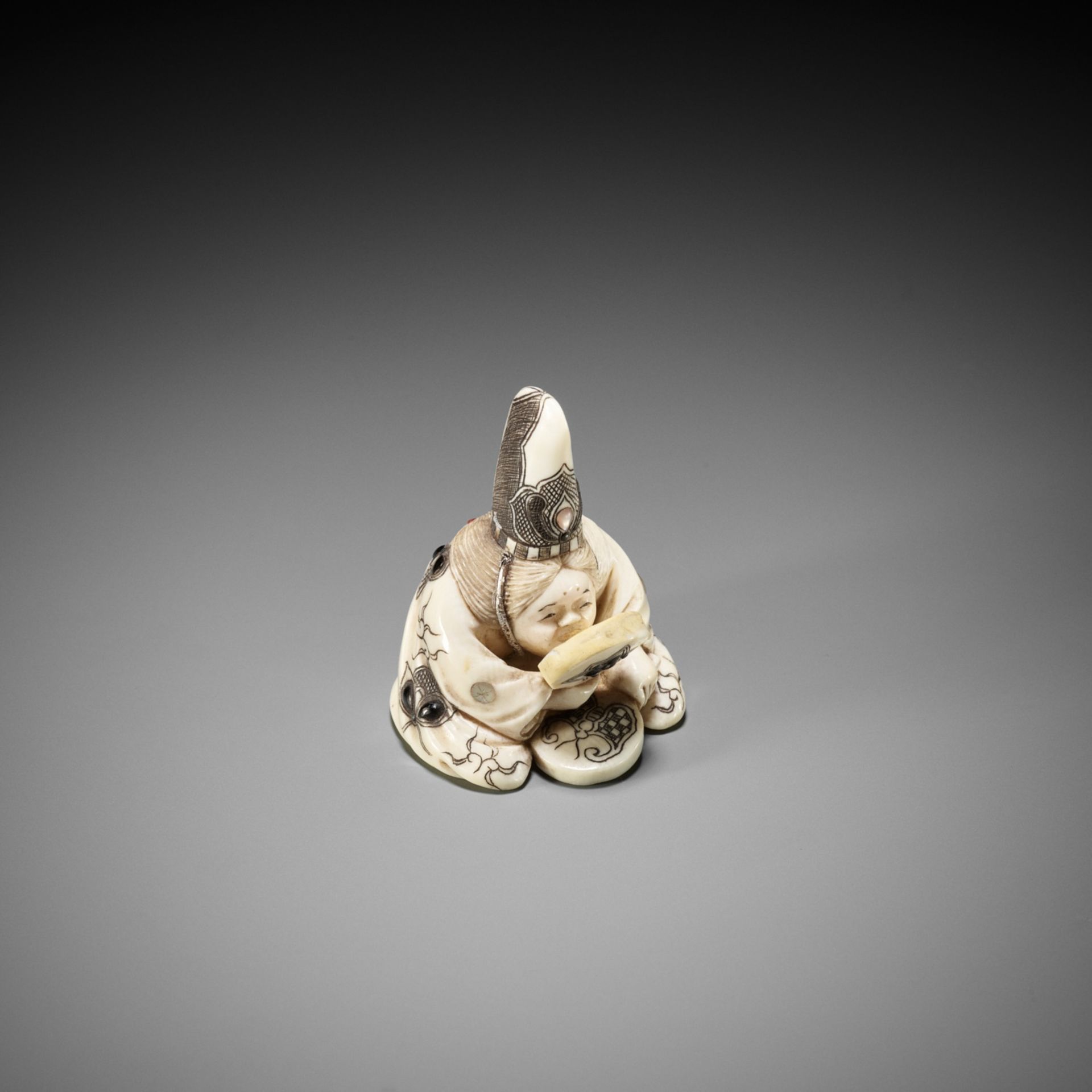 KOKOKU: AN IVORY NETSUKE OF OKAME WITH MIRROR