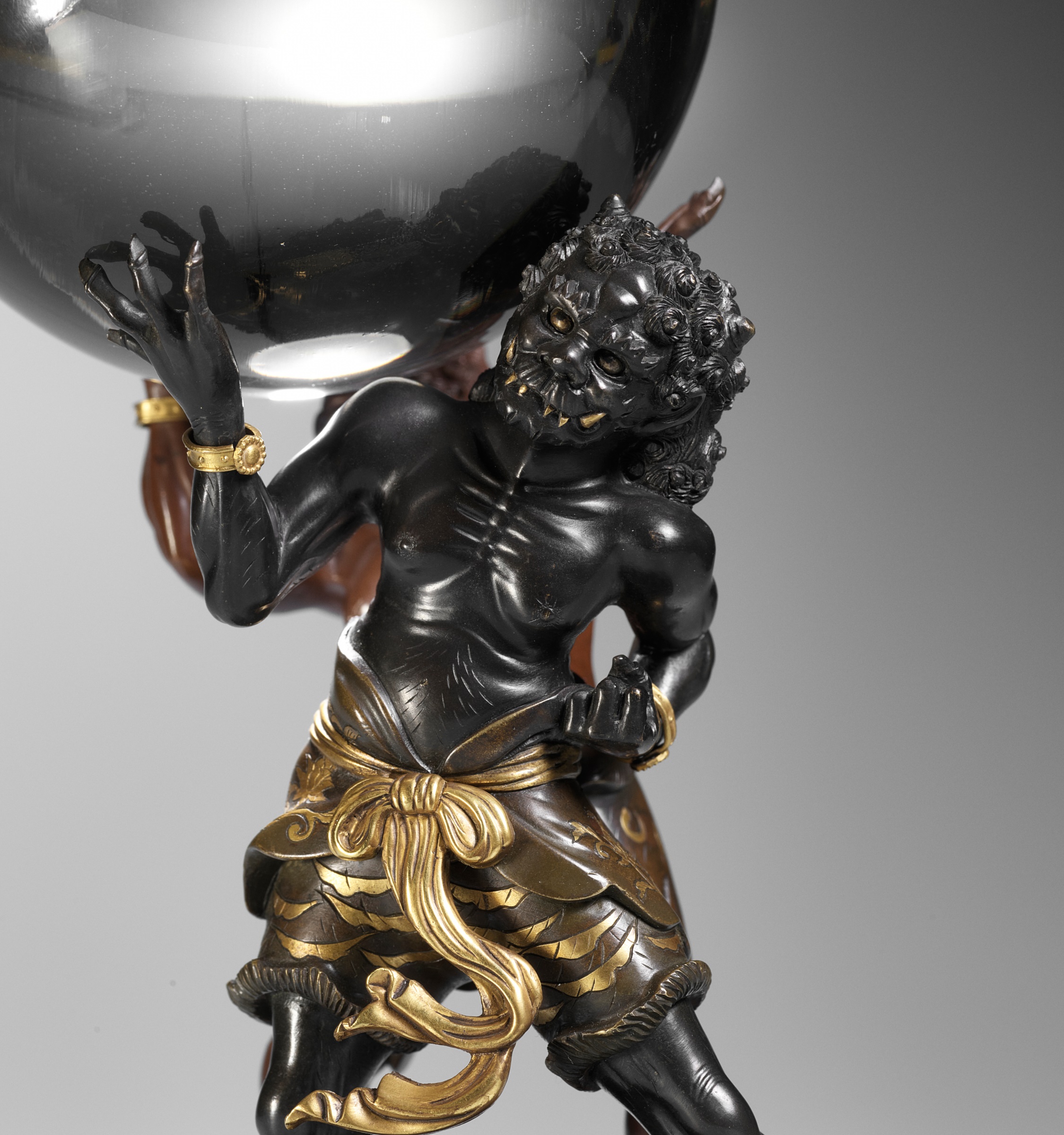 AN IMPRESSIVE BRONZE OF TWO ONI HOLDING A CRYSTAL BALL, ATTRIBUTED TO SANO TAKACHIKA