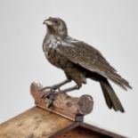 AN UNUSUAL BRONZE AND WOOD GROUP DEPICTING A HAWK ON A BIRDHOUSE